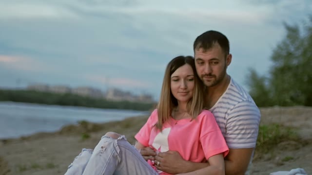 Guy With A Girl Looks At The Bonfire