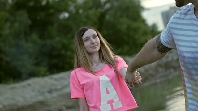 Girl Holds The Guy By The Hand And Goes To Him