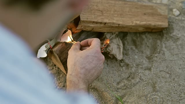 Guy Sets Fire To The Paper With Matches