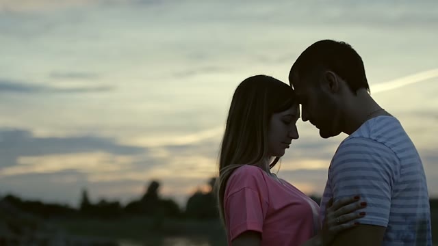 Guy With A Girl Is Standing And Hugging
