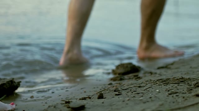 Guy And The Girl Are Walking Along The Sandy Coast