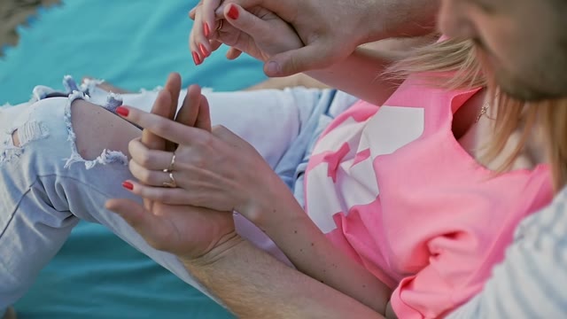 Guy Holds The Girl's Hands In His Hands