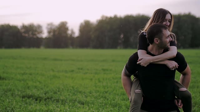 Guy Is Holding The Girl On His Back And Smiling
