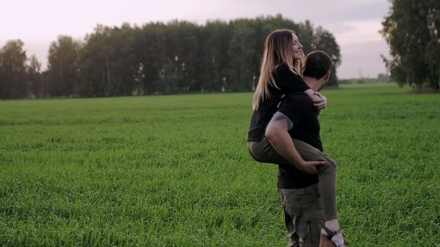 Guy Is Spinning In The Field With The Girl On The Back
