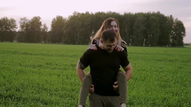 Guy Picks Up The Girl And Holds Her On His Back