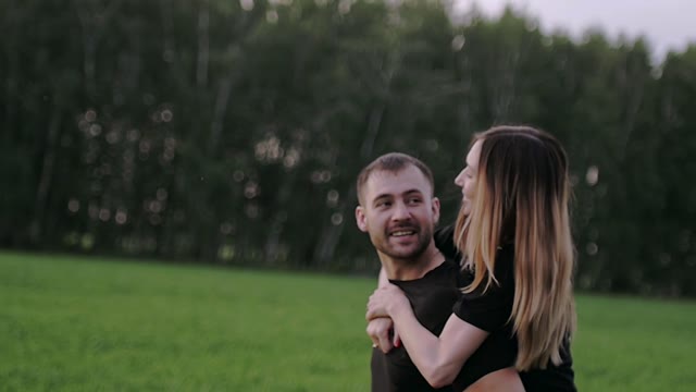 Girl Is Sitting On The Back Of The Guy And Smiling