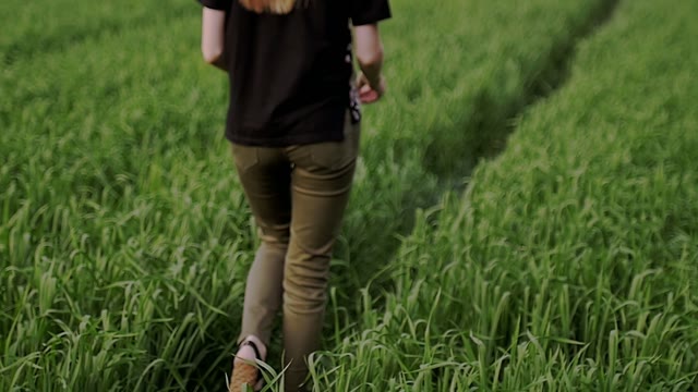 Girl Is Walking Along The Grass To The Guy