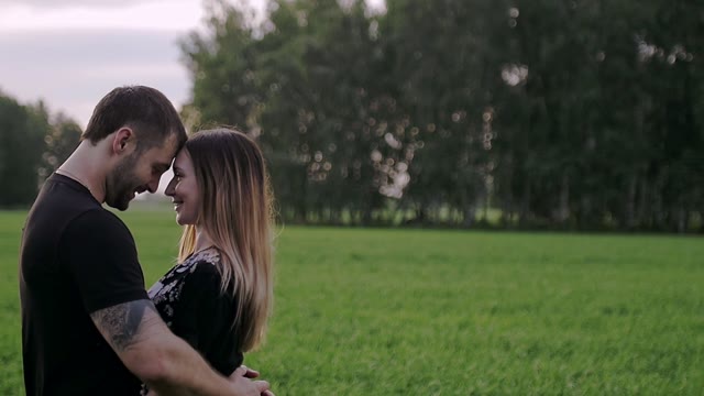 Guy With The Girl Stand Close To Each Other And Smiling
