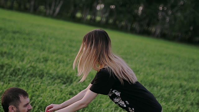 Girl Lies Down On The Guy And They Fall Into The Grass