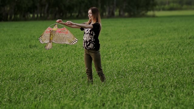 Girl Is Holding A Kite In Her Hands And Releasing It