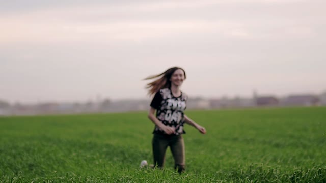 Girl Runs Across The Field And Looks At The Sky