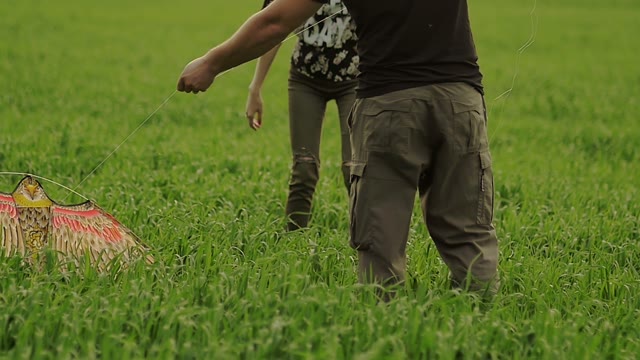 Guy With A Girl Launch A Kite In The Air