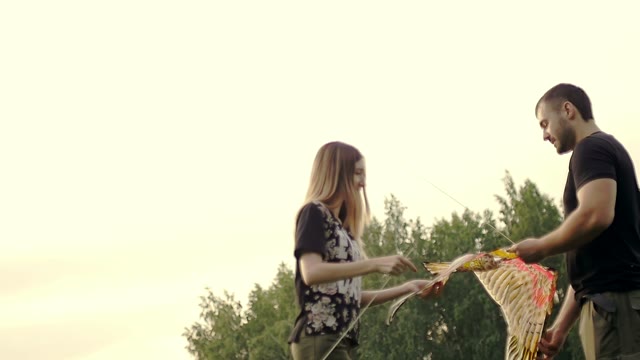Guy With A Girl Construct A Kite