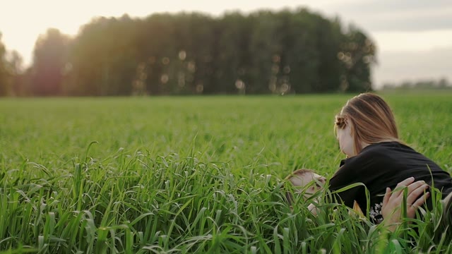 Guy With The Girl Lie On The Grass