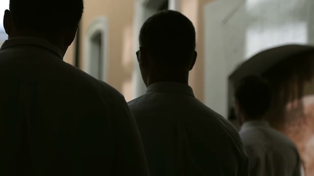 Men Walk Along A Dark Alley