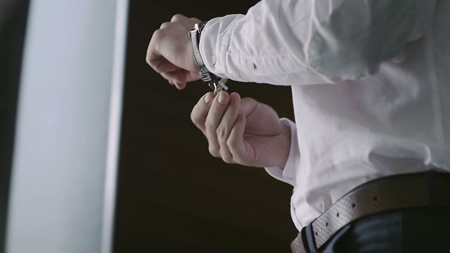 Man Fastens The Watch On His Hand