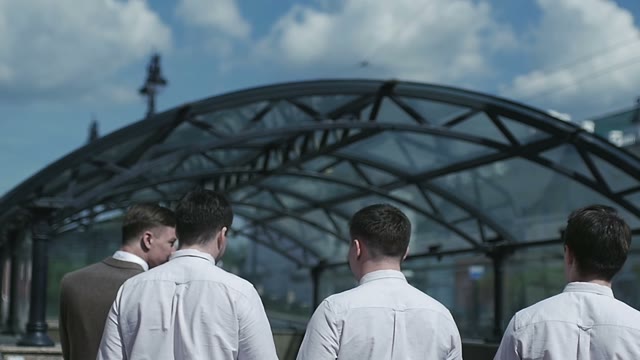 Men In White Shirts Walking Down The Street