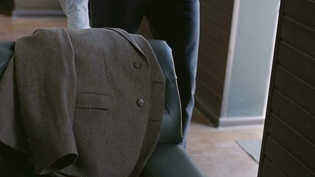 Man Takes A Jacket And Puts It On His Shoulder