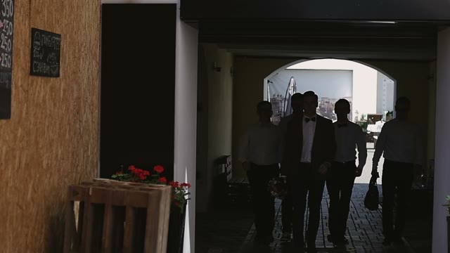 Young Guys Are Walking Along The Alley