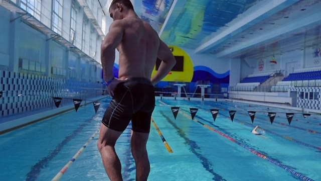 Swimmer Stands On A Tower In The Pool