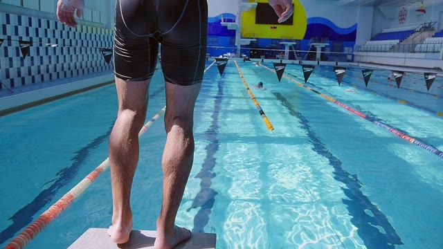 Swimmer Jumps Into The Water From The Tower