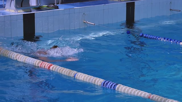 Swimmer Repels From The Wall And Swims