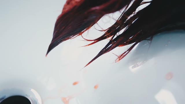 Red Paint Drips From The Hair