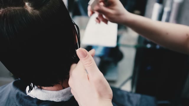 Hairdresser Combs The Wet Hair Of The Client