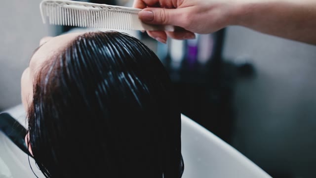 Hairdresser Combs Wet Hair With Hand