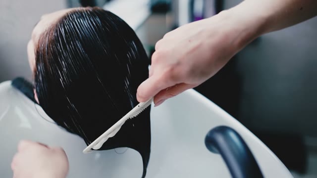 Hairdresser Combs Wet Hair Client's Comb