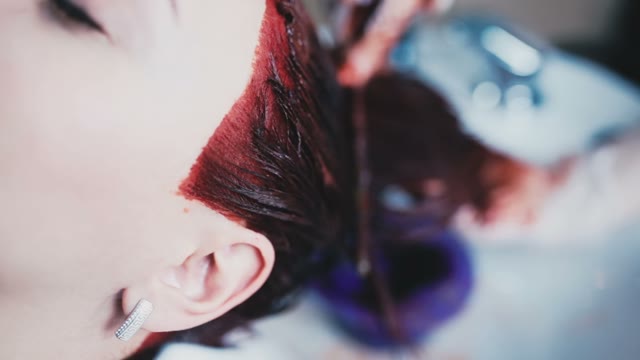 To The Girl Is Wash Off The Excess Paint From The Hair