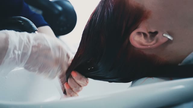 Hairdresser Washes Off Shampoo From Gloves