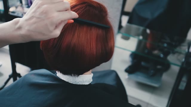 Hairdresser Straightens Hair To Client And Combs Them