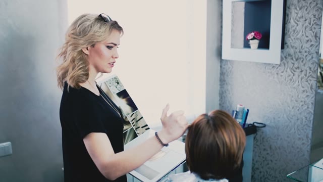 Colorist Helps The Client Choose Hair Color