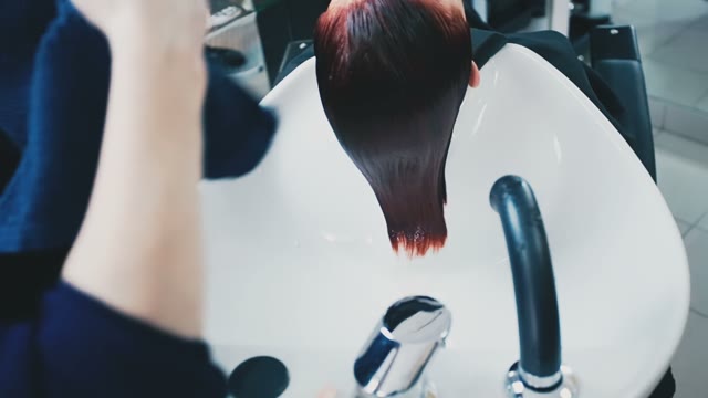 Hairdresser Puts A Towel On Wet Hair To The Client