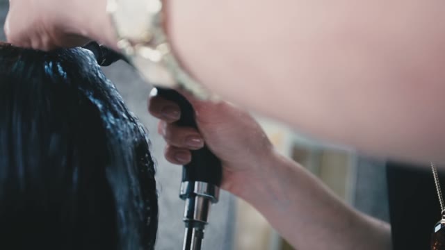 Hairdresser Washes The Shampoo Off The Client's Hair