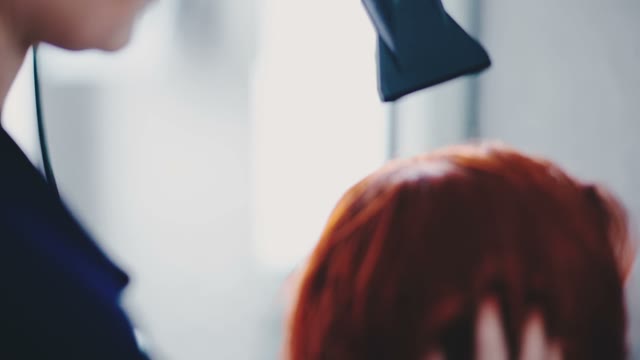 Hairdresser Dries Hair With A Hair Dryer