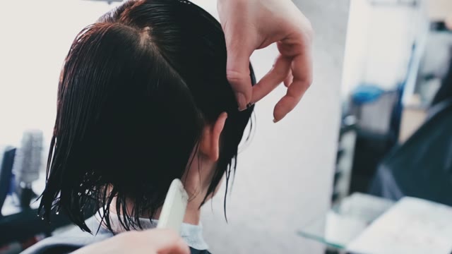 Hairdresser Combs Hair Behind Ear