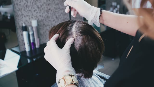 Colorist Separates Strands Of Hair From Each Other