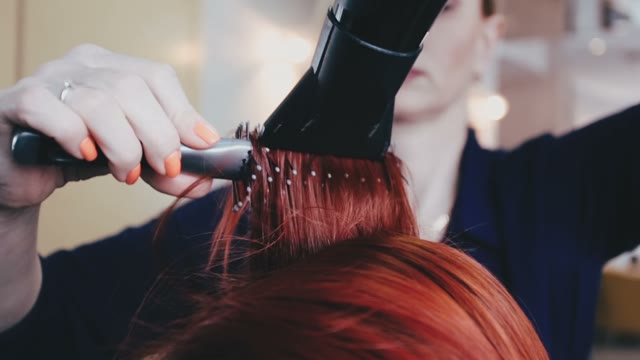 Hairdresser Combs Hair To The Client And Dries Them