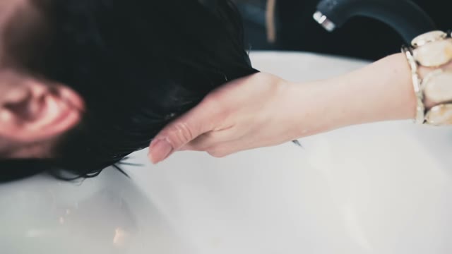 Hairdresser Combs Wet Hair To The Client
