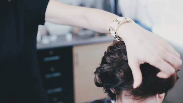 Hairdresser Smooths Hair To The Client