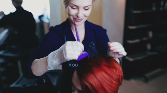 Girl Coloring Hair To Her Client And Smiling