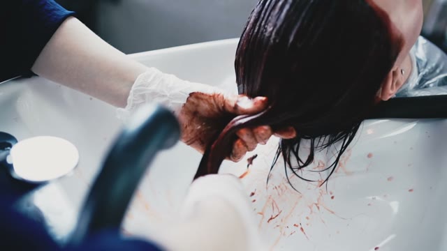 Girl In Gloves Washes The Paint Off Her Hair In The Salon