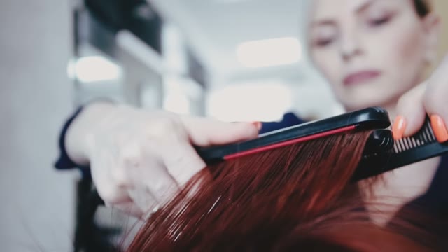 Hairdresser Straightens Hair To Client