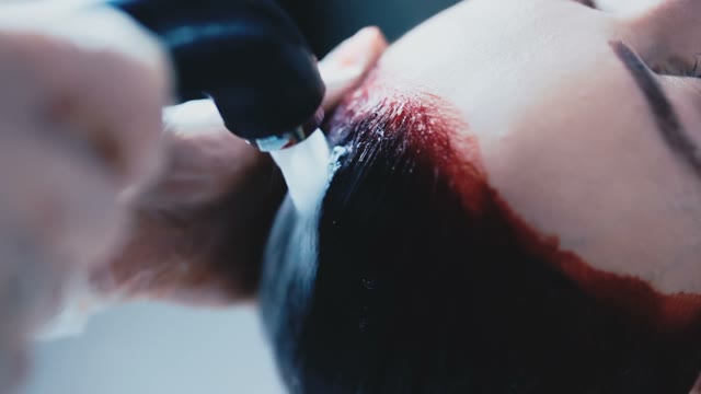Colorist Washes Off The Paint From The Female Hair