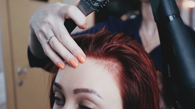Hairdresser Dries Hair To The Client With A Hair Dryer