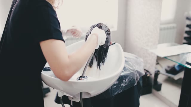 Woman Gently Washing Her Hair To The Client