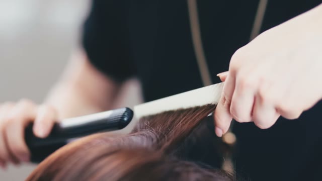 Hairdresser Twists Hair To Client