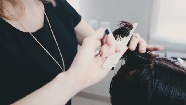 Hairdresser Combs Her Hair And Shears Them